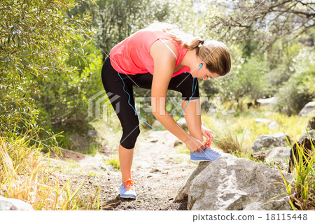 Blonde athlete tying her shoelace Blonde athlete tying her shoelace 18115448