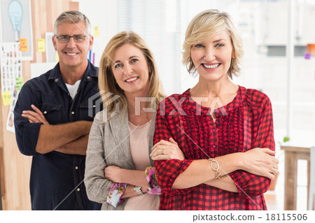 Smiling business team looking at the camera Smiling business team looking at the camera 18115506