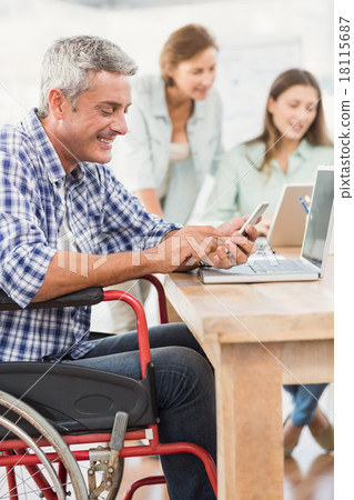 Casual businessman in wheelchair using smartphone 18115687