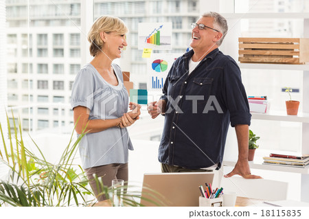 Happy business team laughing together Happy business team laughing together 18115835