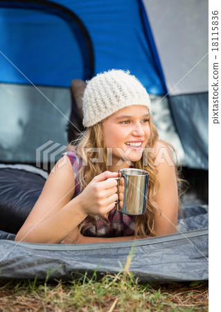 Pretty blonde camper smiling and lying in tent Pretty blonde camper smiling and lying in tent 18115836