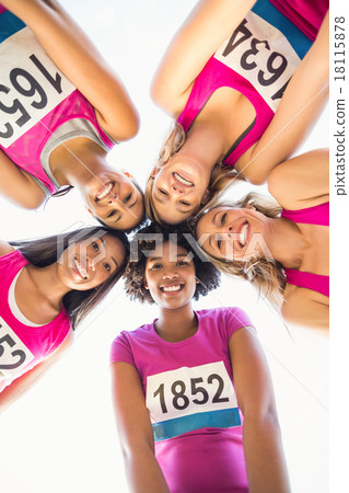 Five smiling runners supporting breast cancer marathon 18115878