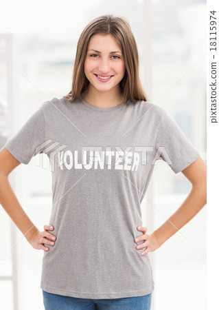 Smiling brunette volunteer with hands on hips Smiling brunette volunteer with hands on hips 18115974