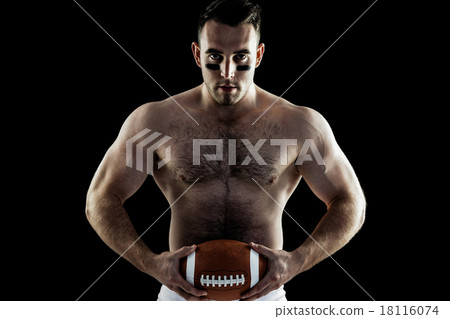 Shirtless American football player with ball 18116074