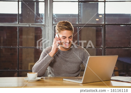 Handsome man smiling and phoning with smartphone Handsome man smiling and phoning with smartphone 18116118