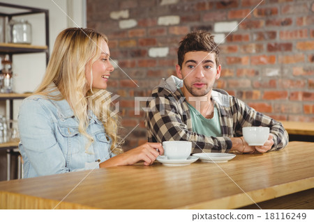 Smiling hipsters sitting and talking 18116249