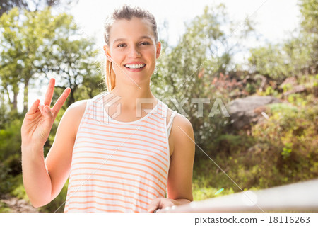 Pretty blonde showing peace sign and taking selfies 18116263