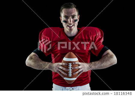 American football player holding a ball American football player holding a ball 18116348