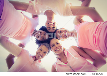 Women wearing pink for breast cancer with arms around 18116589