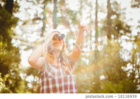 Pretty young blonde looking through binoculars 18116939