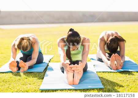 Sporty women stretching on exercise mat 18117158