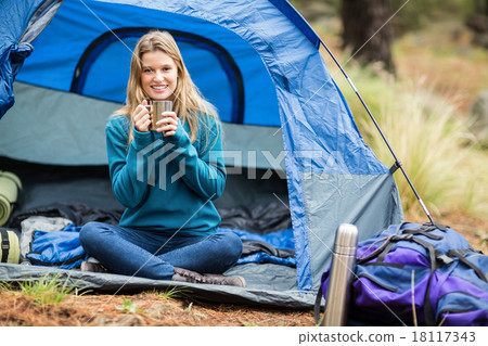 Portrait of a young pretty hiker sitting in a tent Portrait of a young pretty hiker sitting in a tent 18117343