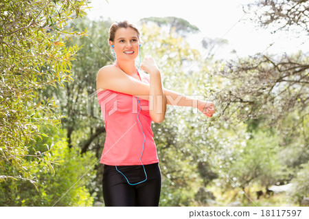 Smiling blonde athlete stretching arms 18117597