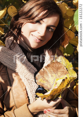 Young woman playing with autumn colorful leaves Young woman playing with autumn colorful leaves 18122272