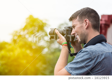 photographer with professional digital camera photographer with professional digital camera 18123915