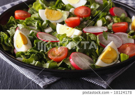 Salad with eggs and spring vegetables close-up 18124178