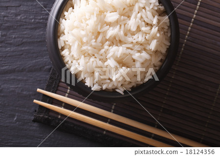 White rice in a black bowl. horiozntal top view White rice in a black bowl. horiozntal top view 18124356