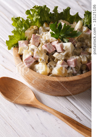 Russian salad Olivier close up in a wooden bowl 18125186
