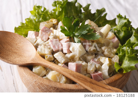 Russian salad close up in a wooden bowl horizontal 18125188