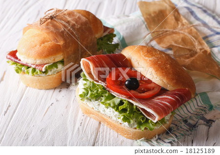Sandwiches with jamon, soft cheese and vegetables 18125189