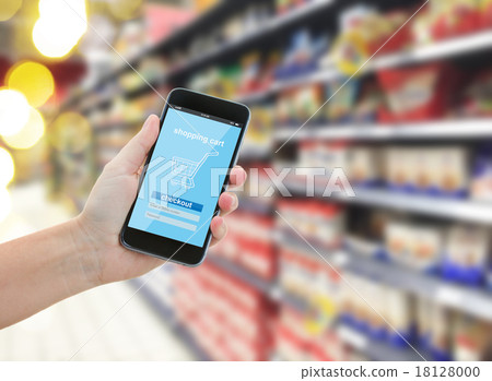hand holding a modern smartphone in supermarket hand holding a modern smartphone in supermarket 18128000