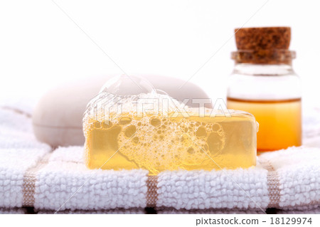 Herbal spa soap bar on white bath towel . Herbal spa soap bar on white bath towel . 18129974