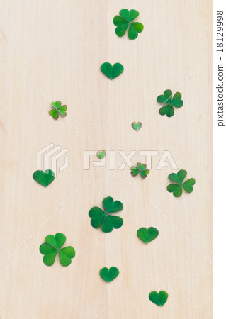 Closeup clovers leaves on wooden background. Closeup clovers leaves on wooden background. 18129998