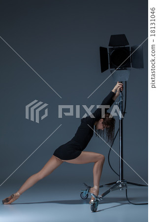 The beautiful ballerina posing on dack blue The beautiful ballerina posing on dack blue 18131046