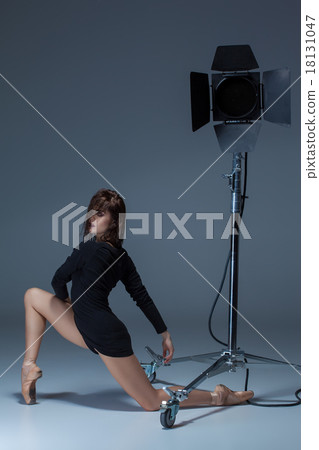 The beautiful ballerina posing on dack blue The beautiful ballerina posing on dack blue 18131047