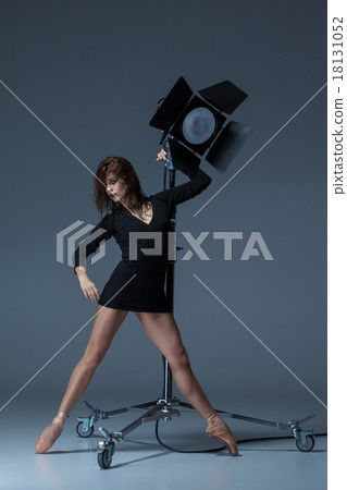 The beautiful ballerina posing on dack blue The beautiful ballerina posing on dack blue 18131052
