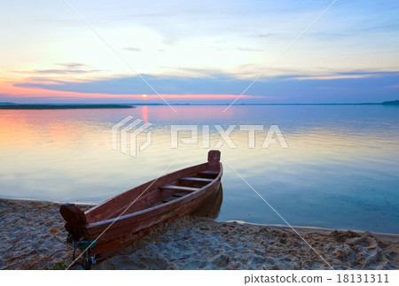 Sunset with boat near the summer lake shore 18131311