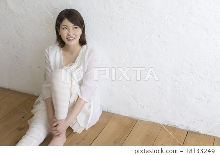 Young lady sitting on flooring Young lady sitting on flooring 18133249