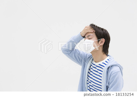 A young man who masks and puts his hand on his forehead A young man who masks and puts his hand on his forehead 18133254