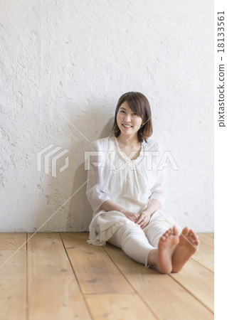 Young lady sitting on flooring 18133561