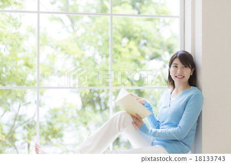 Young lady sitting on the window side 18133743