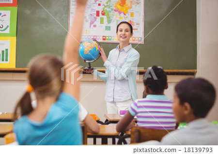 Pupils listening to their teacher holding globe Pupils listening to their teacher holding globe 18139793
