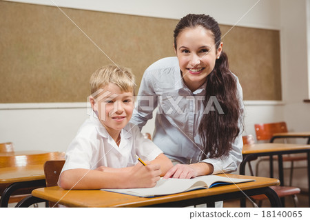 Teacher helping a student in class 18140065
