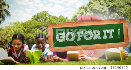 Go for it! against children lying on grass and reading books Go for it! against children lying on grass and reading books 18140235