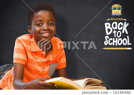 Composite image of cute boy reading book in library Composite image of cute boy reading book in library 18140486