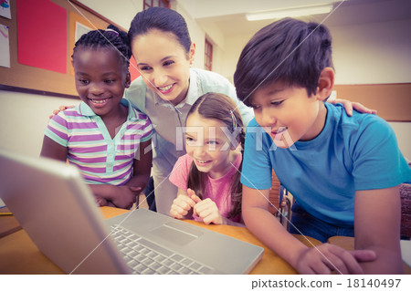 Teacher using laptop with pupils Teacher using laptop with pupils 18140497
