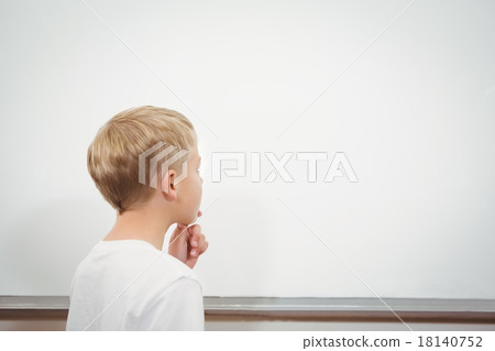 Puzzled student looking at whiteboard 18140752