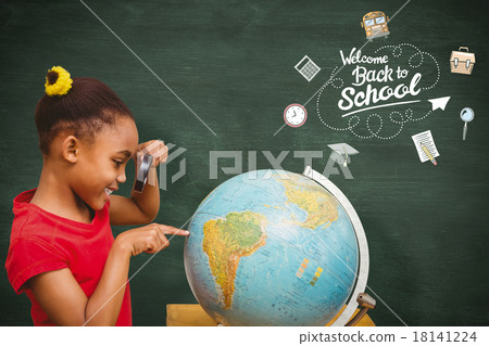 Composite image of pupil studying the globe Composite image of pupil studying the globe 18141224