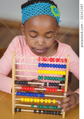 Focused pupil calculating with abacus in a classroom Focused pupil calculating with abacus in a classroom 18141397