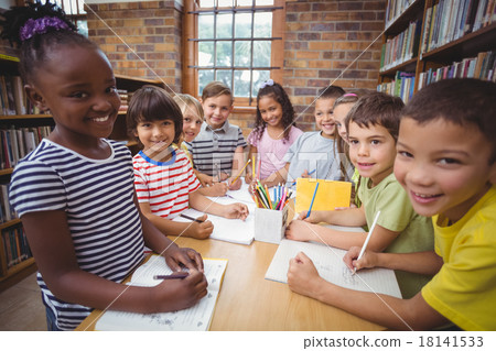 Pupils working together at desk in library Pupils working together at desk in library 18141533