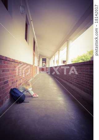 Sad pupil sitting alone on ground 18142017