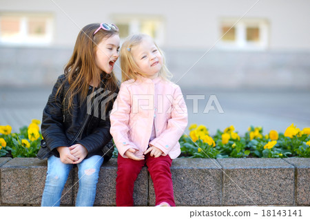 Portrait of two cute little sisters outdoors Portrait of two cute little sisters outdoors 18143141