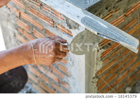 plasterer concrete worker at wall of house construction plasterer concrete worker at wall of house construction 18145379