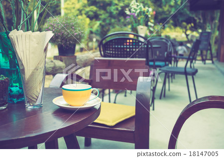 Coffee cup on table in cafe with vintage color tone Coffee cup on table in cafe with vintage color tone 18147005