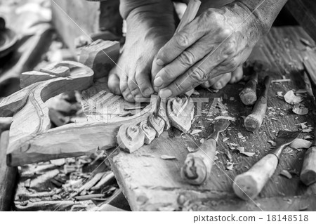 Hand of carver carving wood in black and white color tone Hand of carver carving wood in black and white color tone 18148518