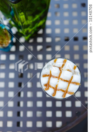 Caramel cappuccino coffee glass on table in cafe 18148708